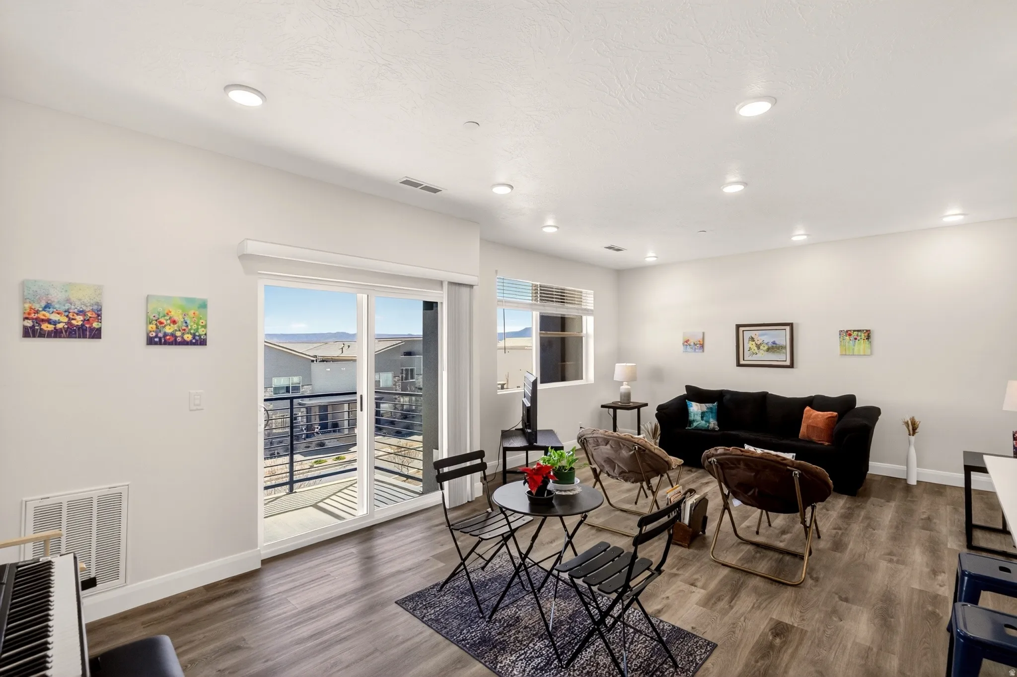 Living area with wood finished floors and recessed lighting