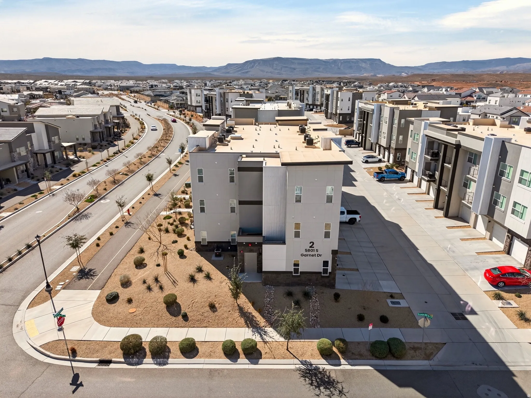 Aerial perspective of suburban area featuring a mountainous background