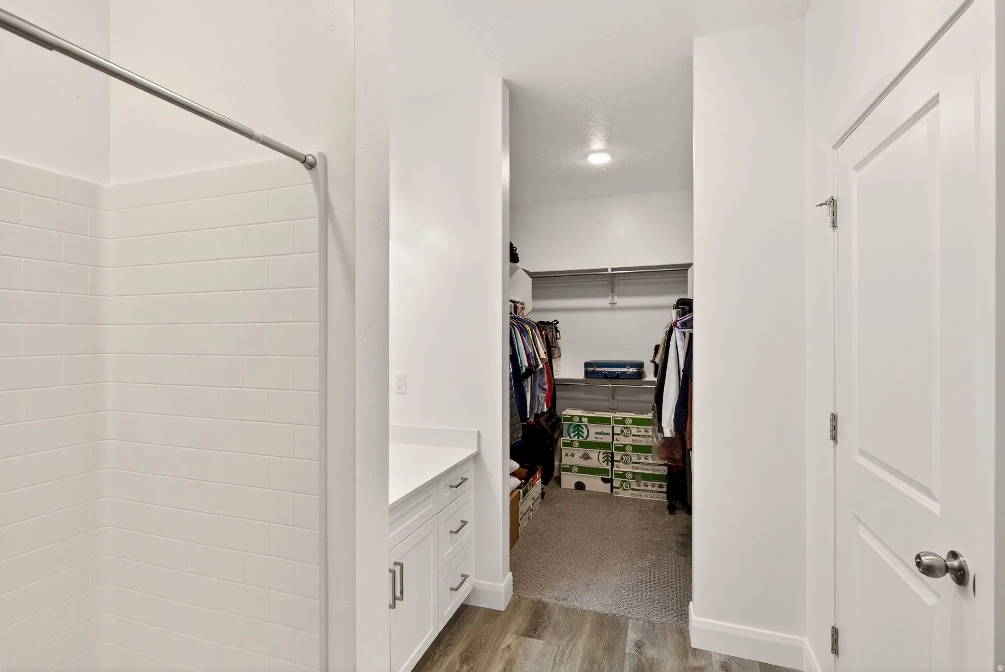 Walk in closet with light wood-style flooring