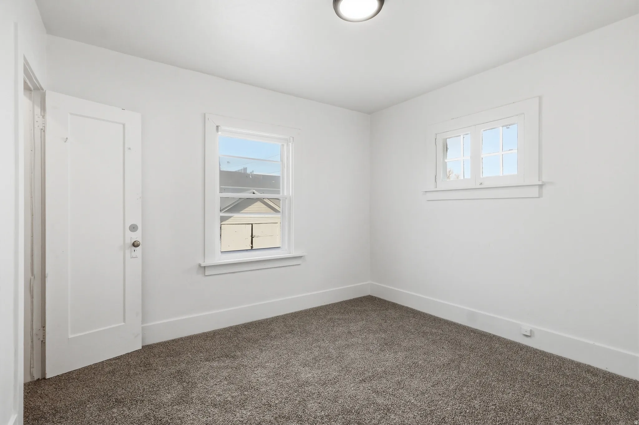 Carpeted empty room with baseboards