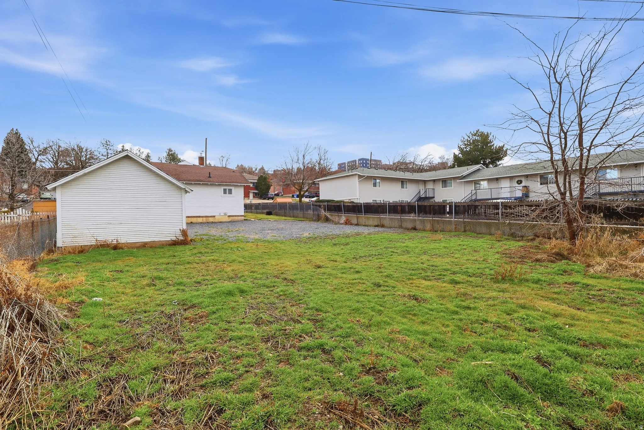 Fenced backyard featuring a residential view