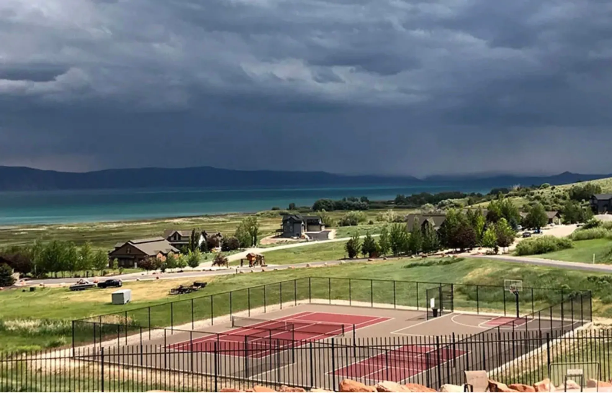 View of property's community with a water view and community basketball court