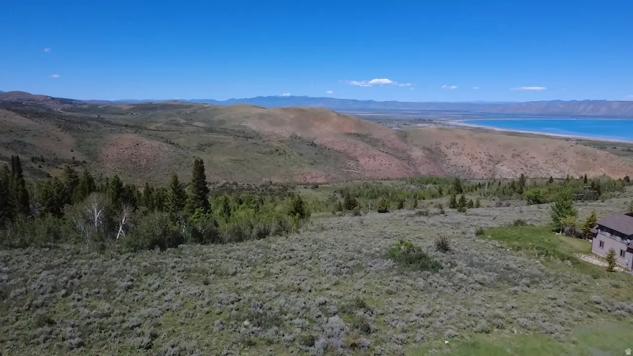 Expansive natural landscape with varied terrain and distant water body