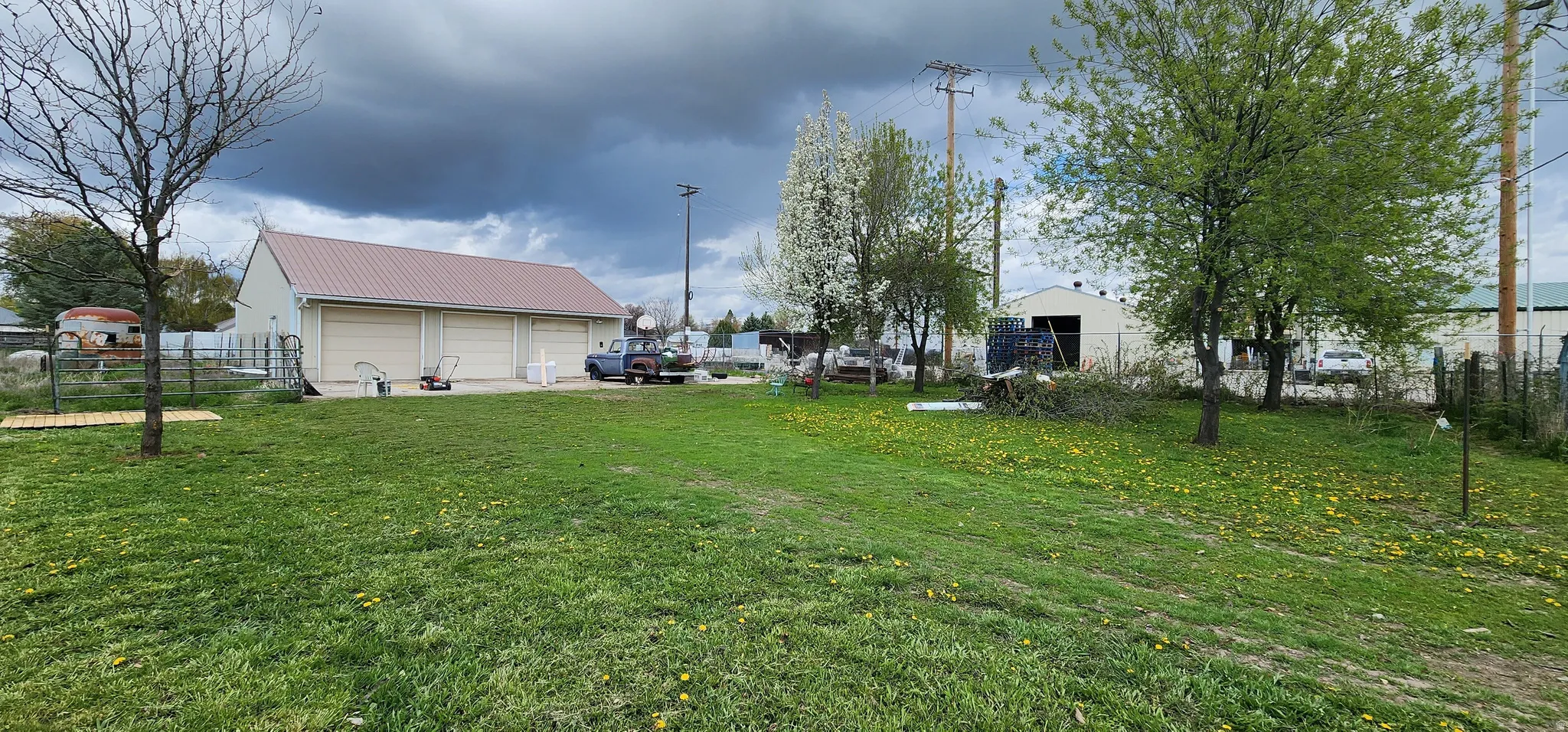 View of yard featuring a detached garage and an outbuilding
