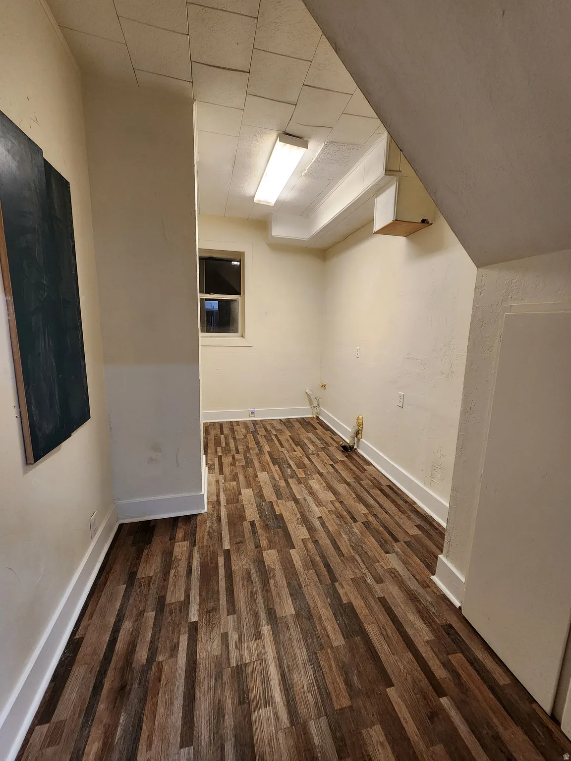 Room with dark wood finished floors and baseboards