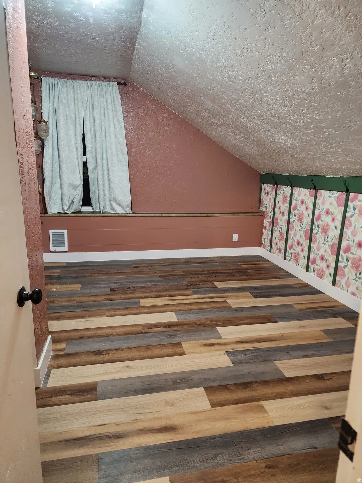 Bedroom with wood finished floors and heating unit