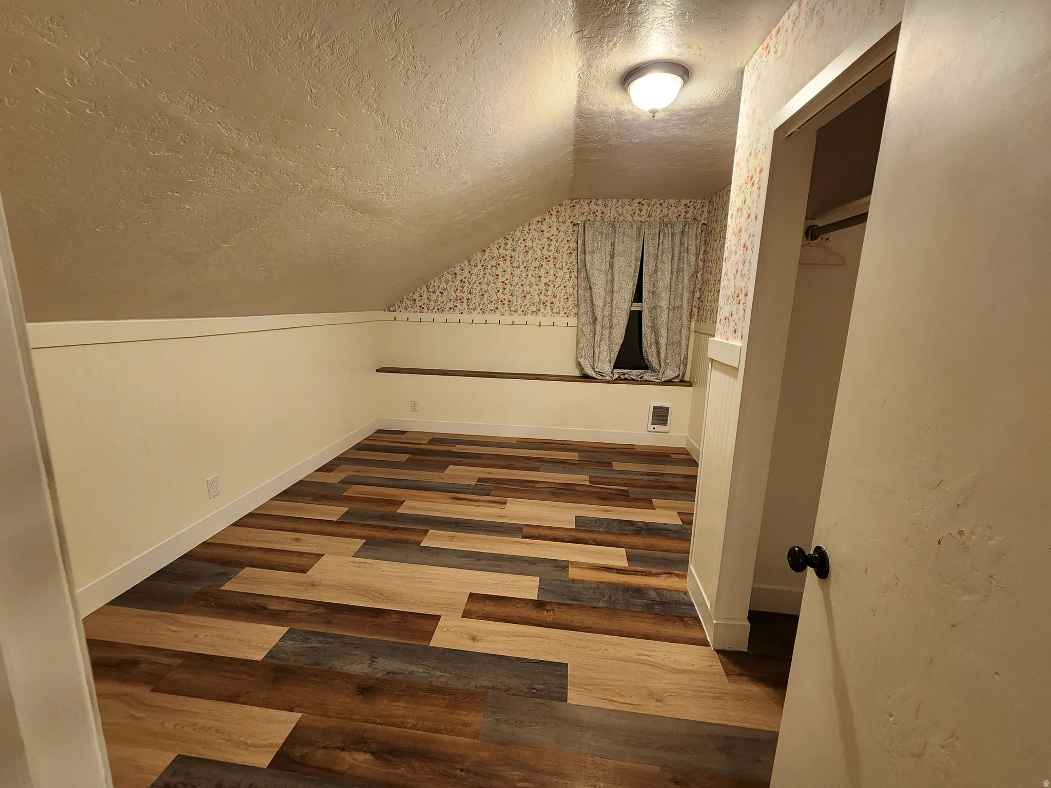Additional living space with wood finished floors and wainscoting