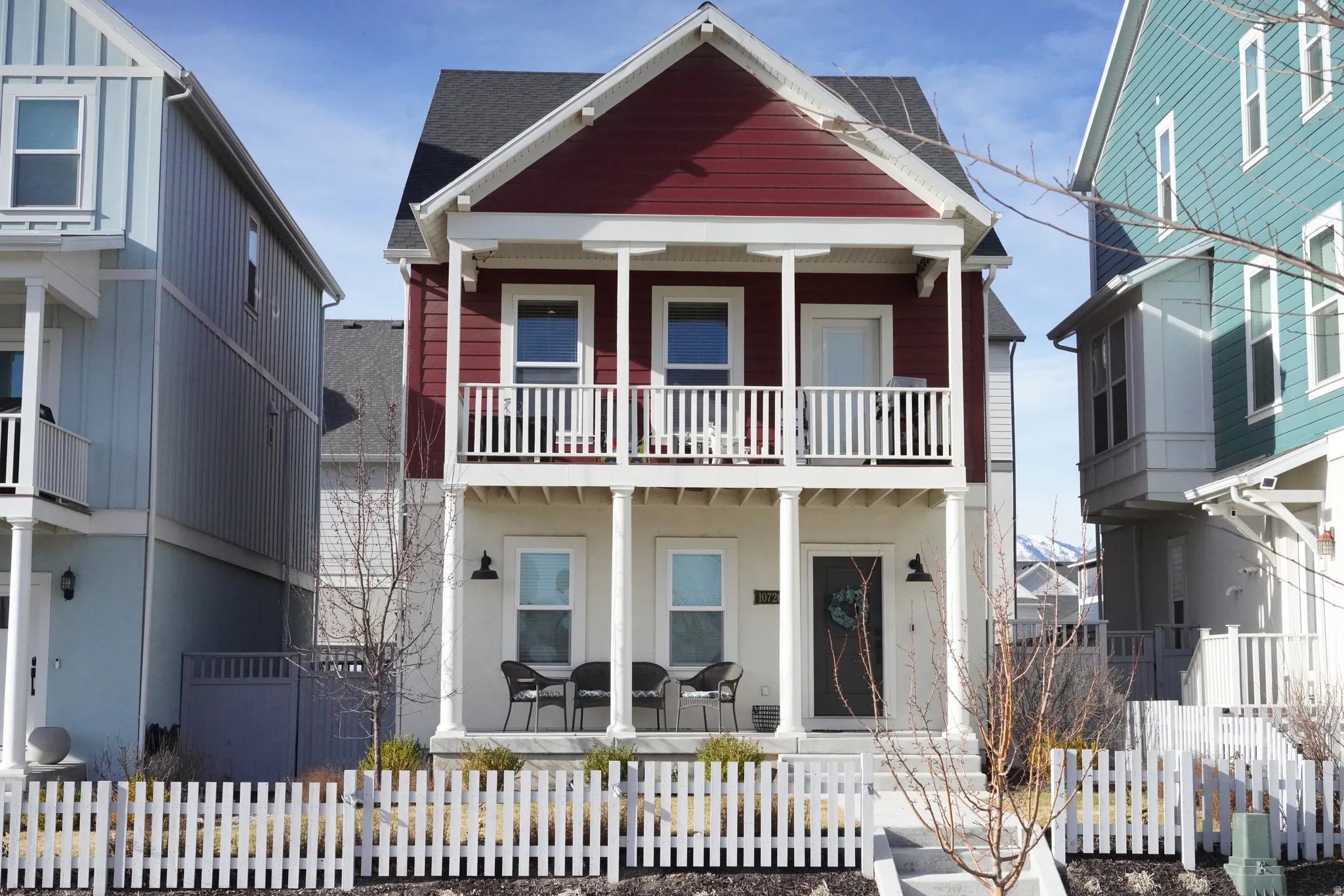 View of front facade with covered porch and a fenced front yard