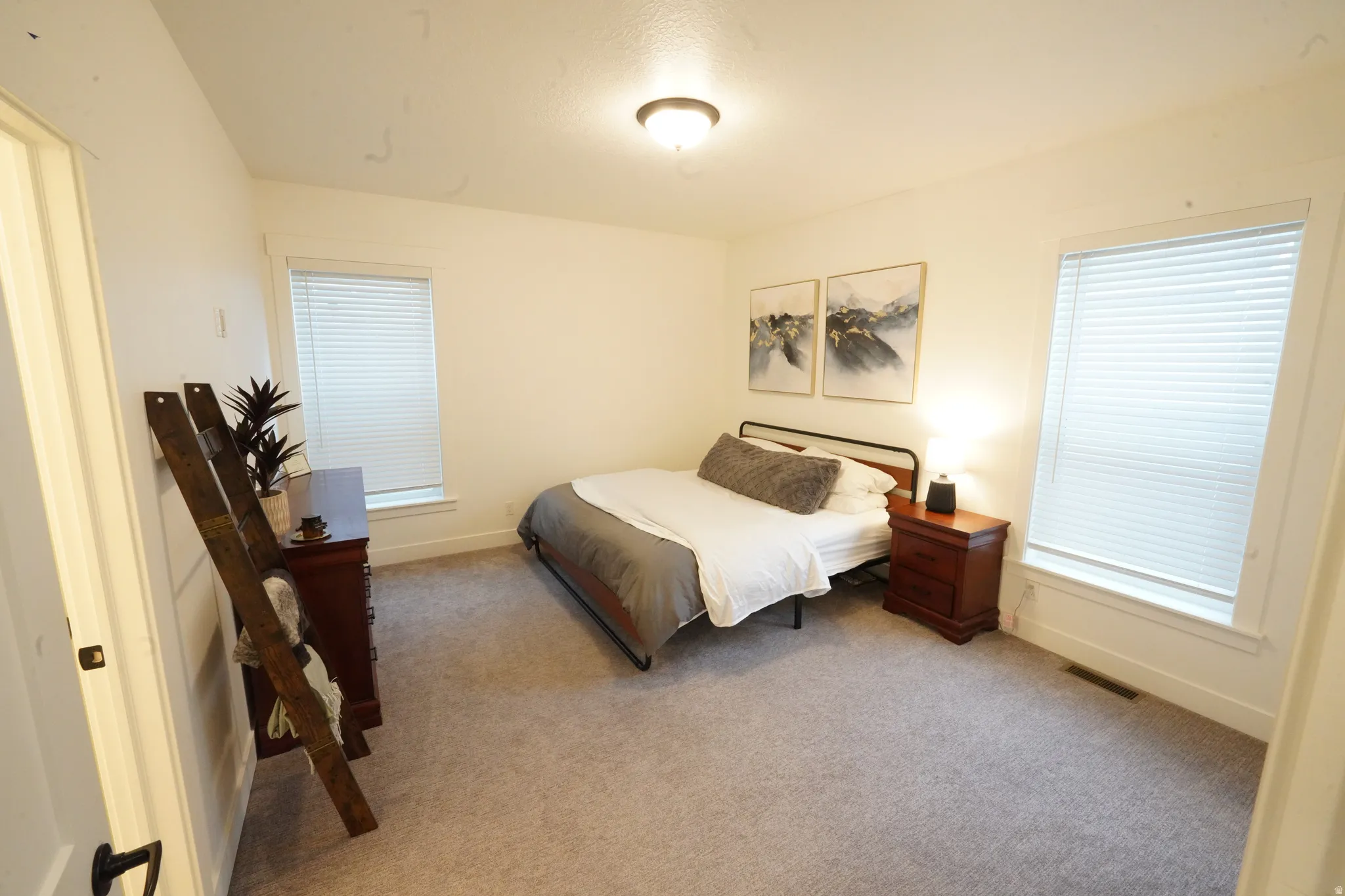 Bedroom with light carpet and baseboards