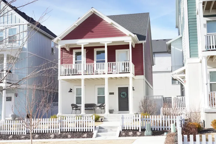 View of front of house featuring covered porch and a shingled roof