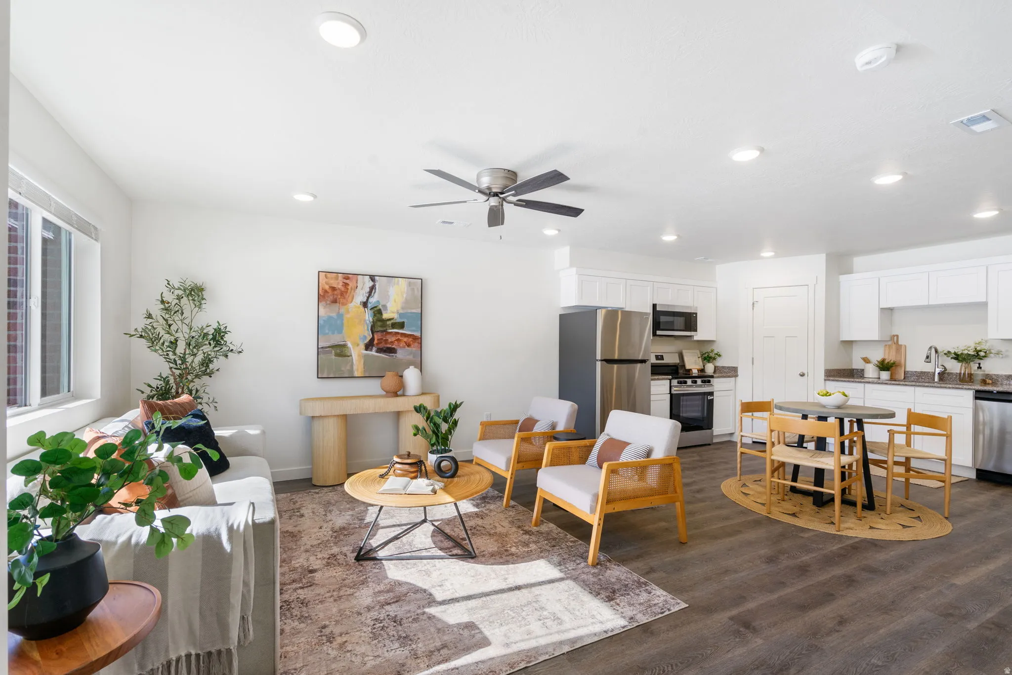 Living room with ceiling fan, dark wood finished floors, and recessed lighting