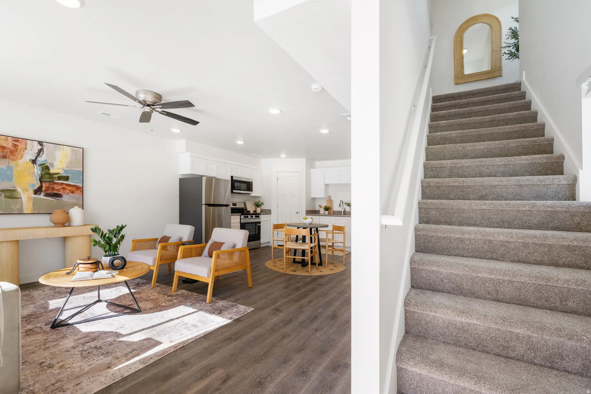 Stairway featuring a ceiling fan, wood finished floors, and recessed lighting
