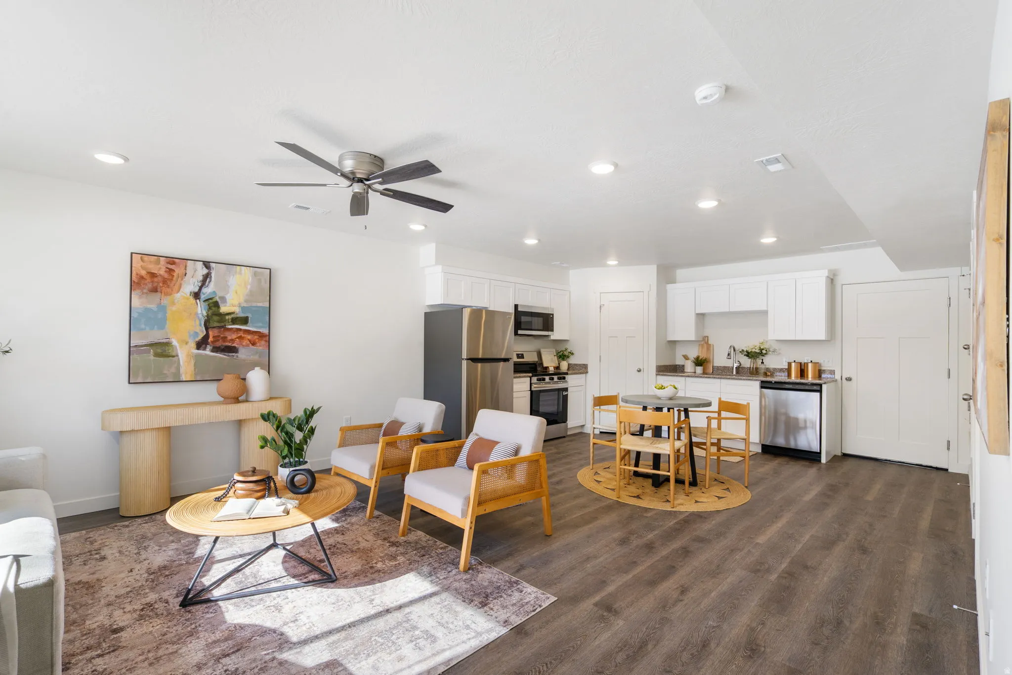 Living room with ceiling fan, dark wood-style flooring, and recessed lighting