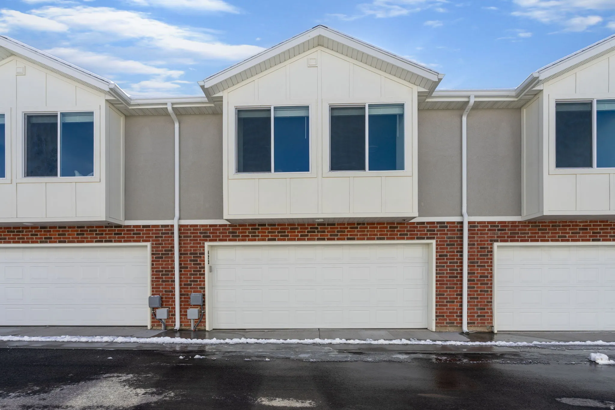 View of front of house featuring a garage and board and batten siding