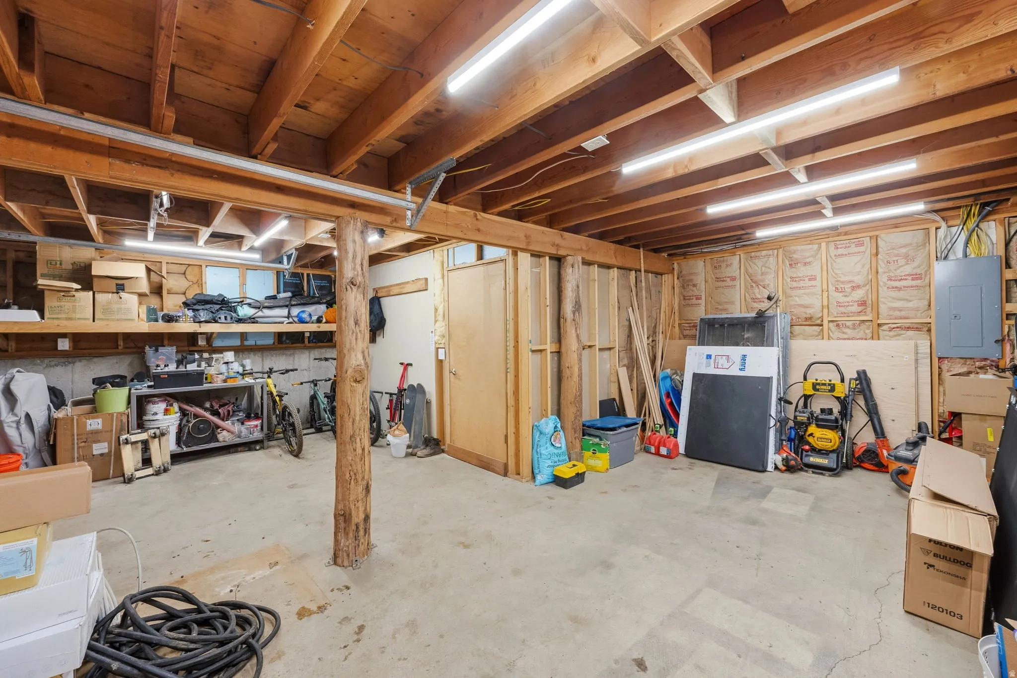 Unfinished basement with electric panel
