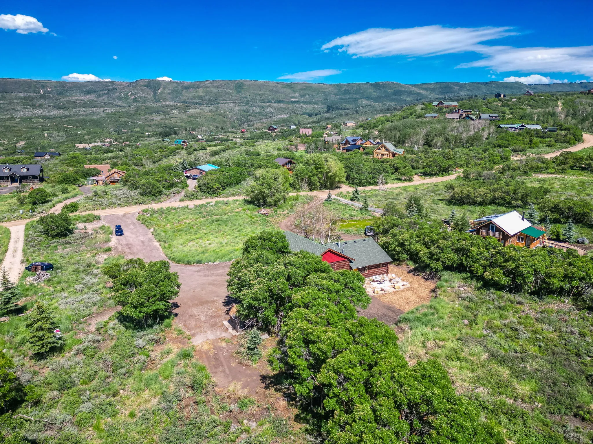 Mountainous terrain with lush green vegetation under a clear blue sky