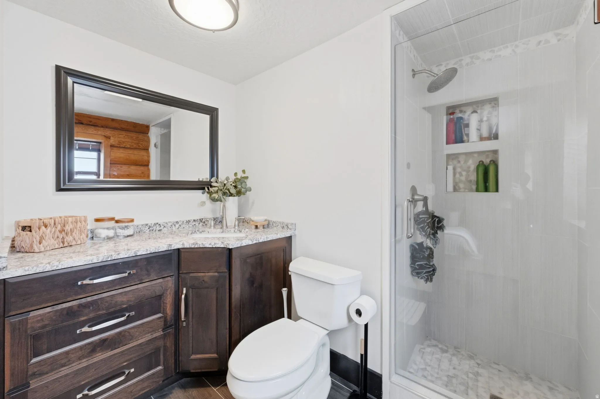 Full bathroom featuring vanity, a tile shower, and a textured ceiling