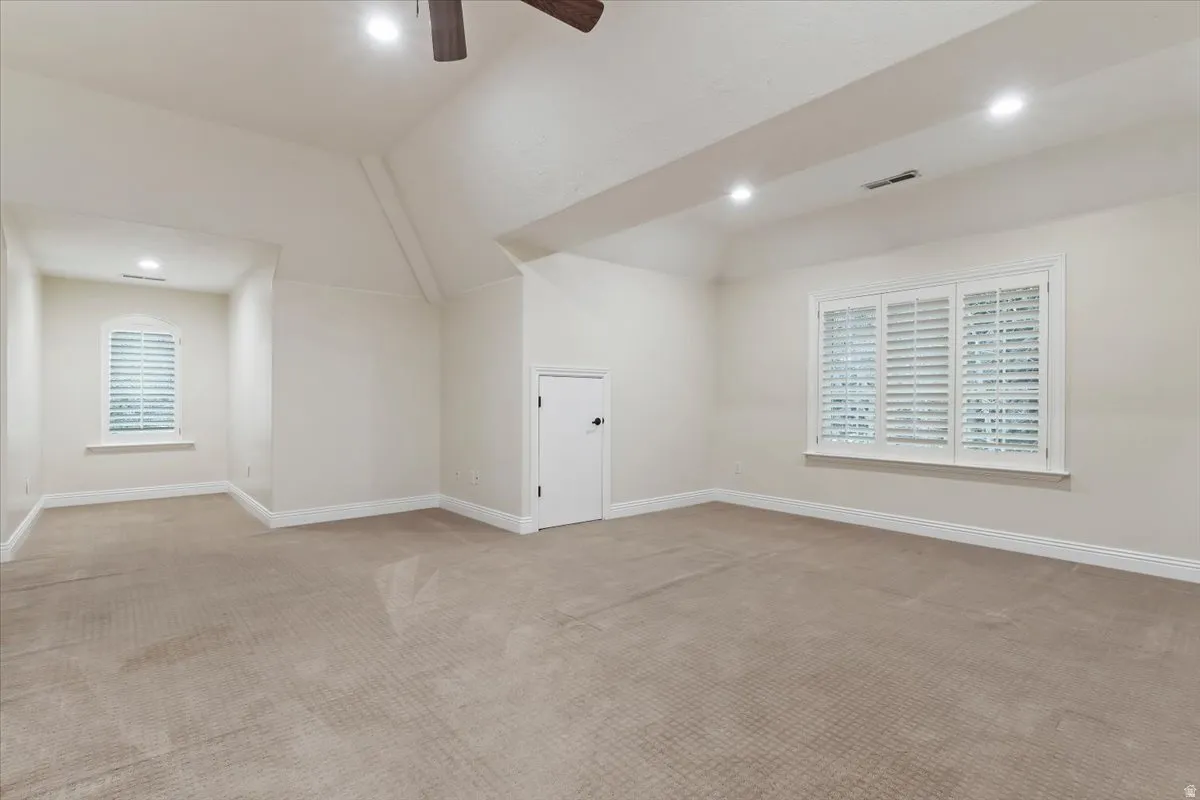 Additional living space with a ceiling fan, light carpet, recessed lighting, and vaulted ceiling