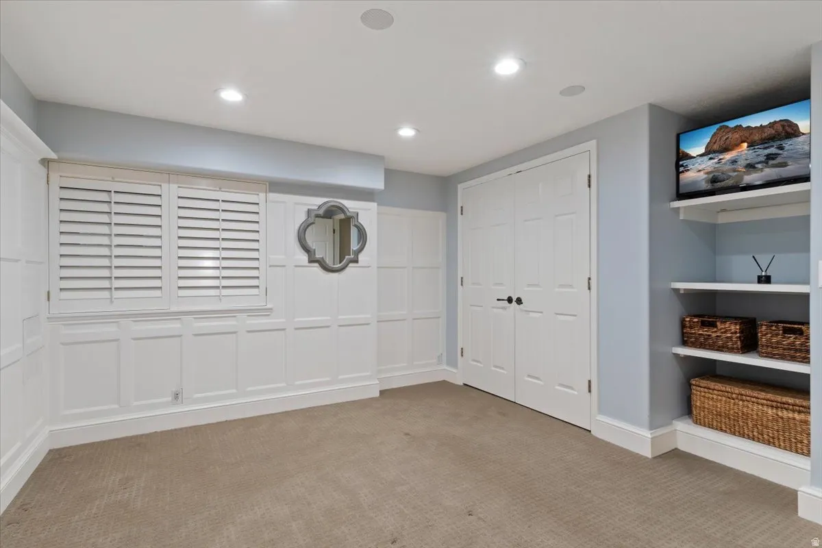 Unfurnished bedroom featuring carpet floors, recessed lighting, and a closet