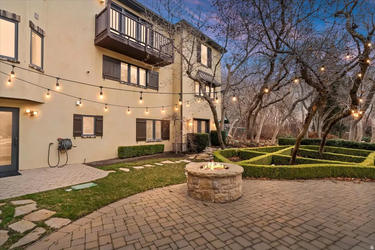 View of home's community with a fire pit, a patio, and a balcony