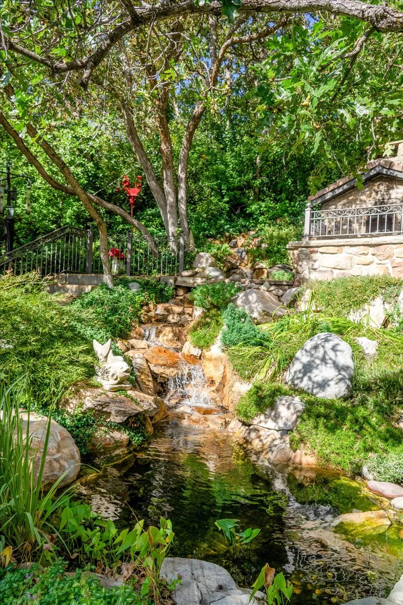 View of yard with a garden pond