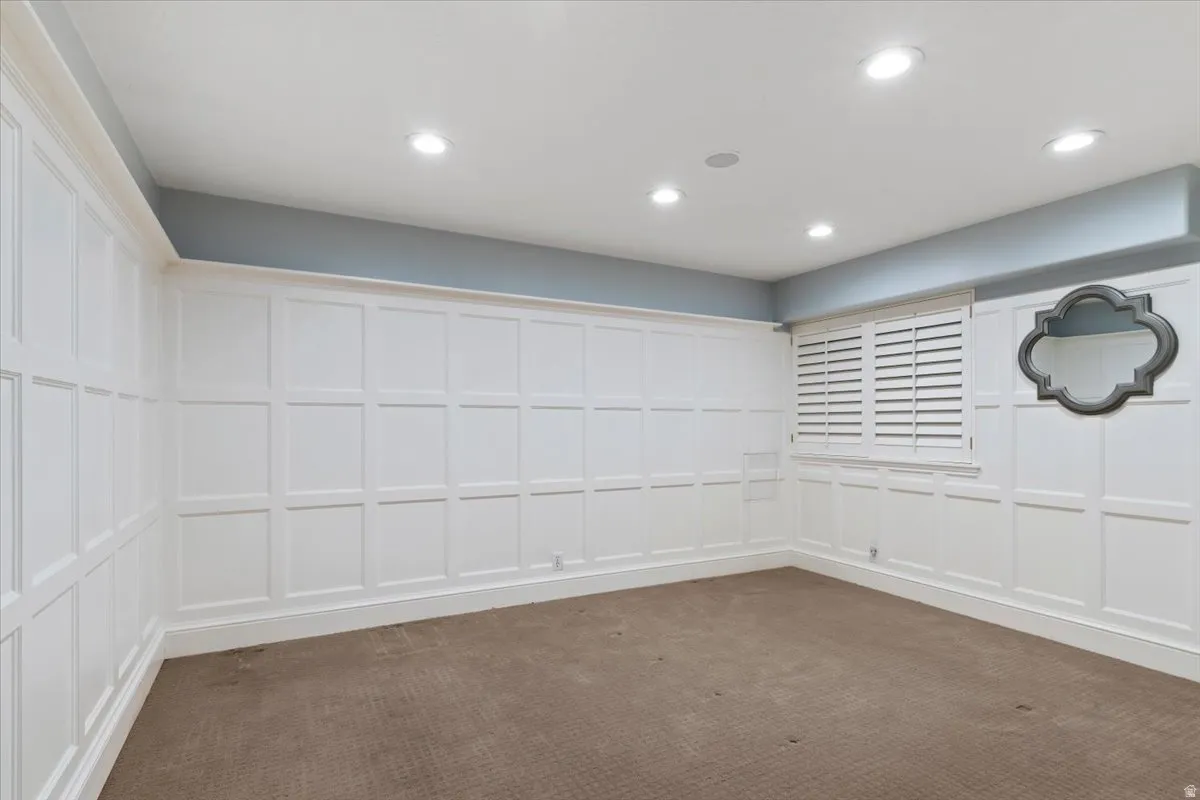 Empty room with a decorative wall and recessed lighting