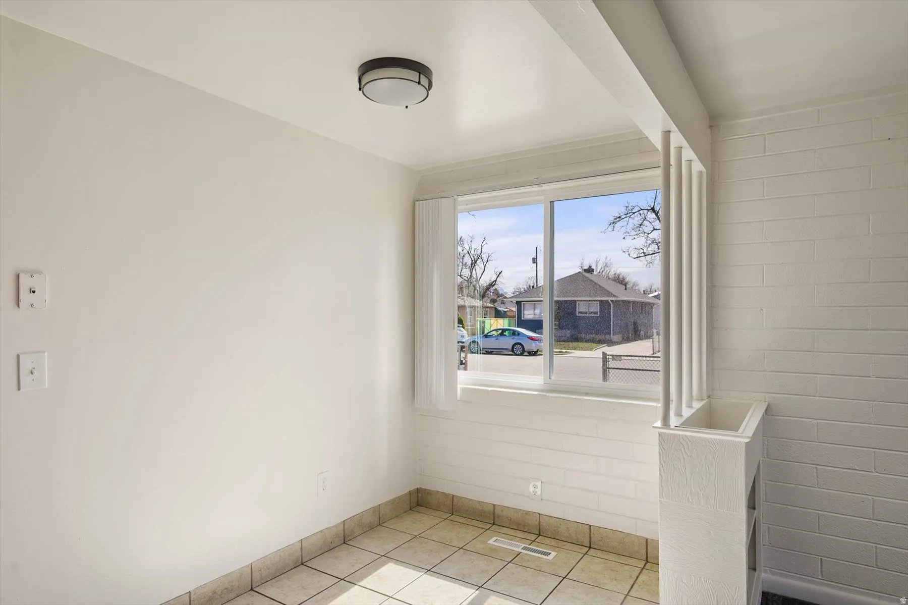 Spare room with light tile patterned floors and baseboards