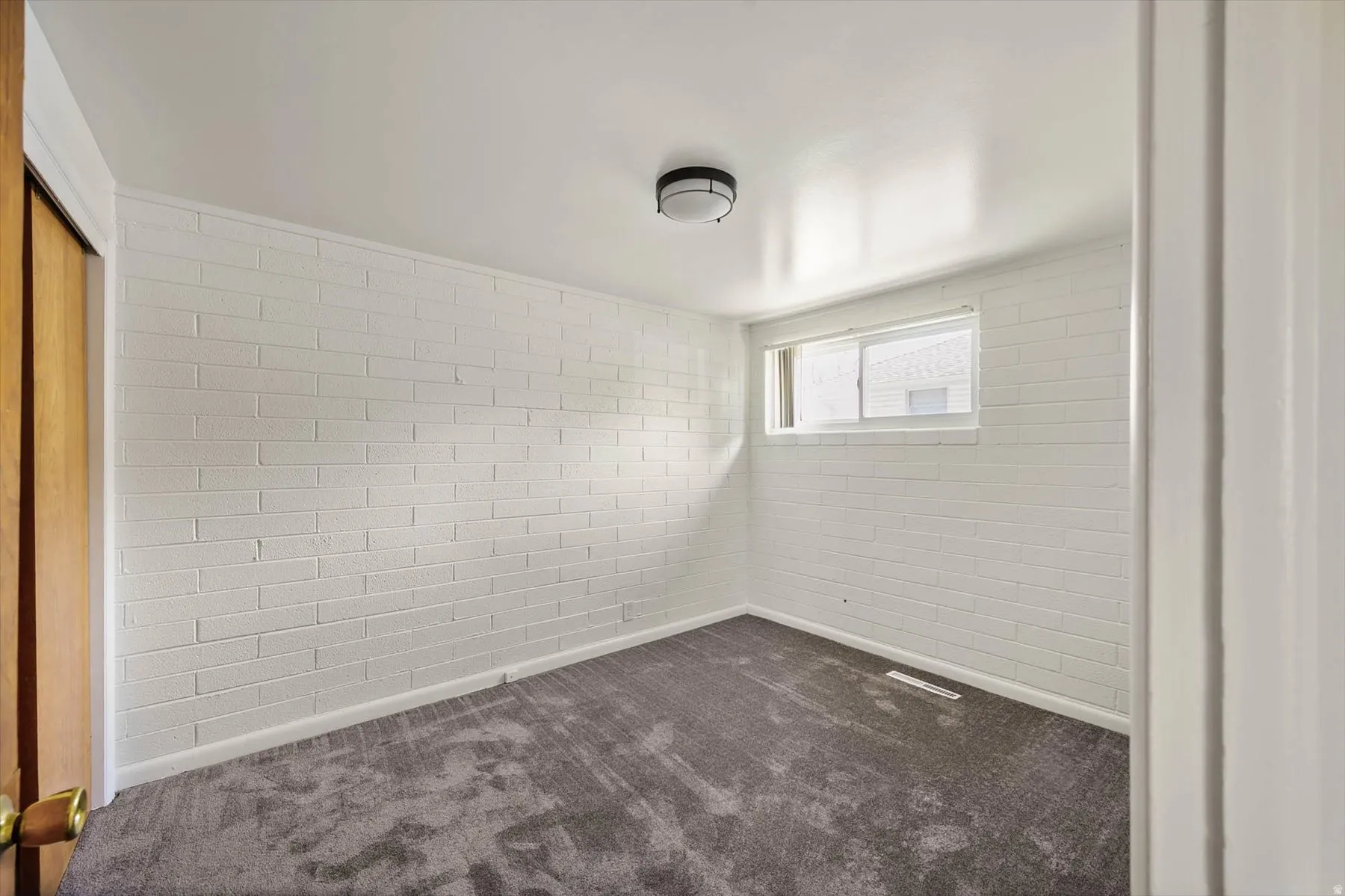 Spare room featuring dark carpet