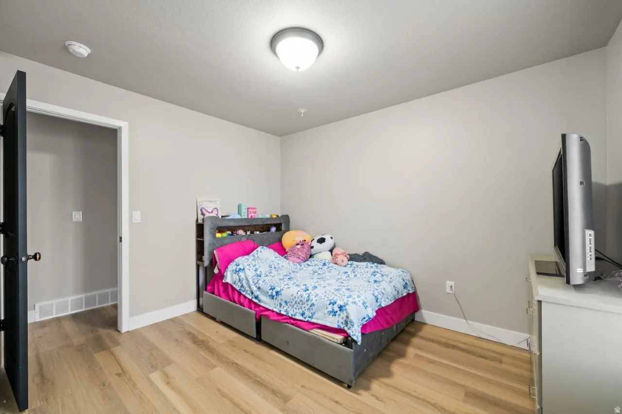 Light wood-finish flooring complements neutral wall tones and white baseboards