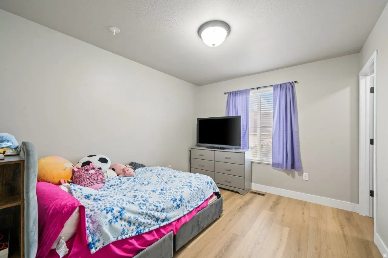 Bright interior space featuring light-toned walls and wood-finish flooring