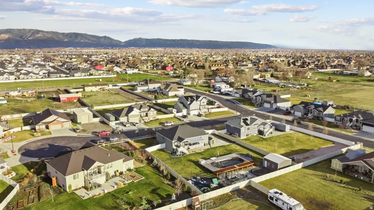 Aerial view of residential area featuring a mountainous background