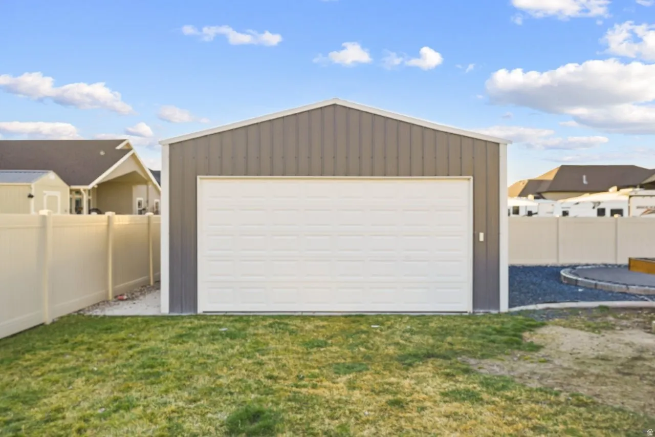 Detached garage featuring a residential view