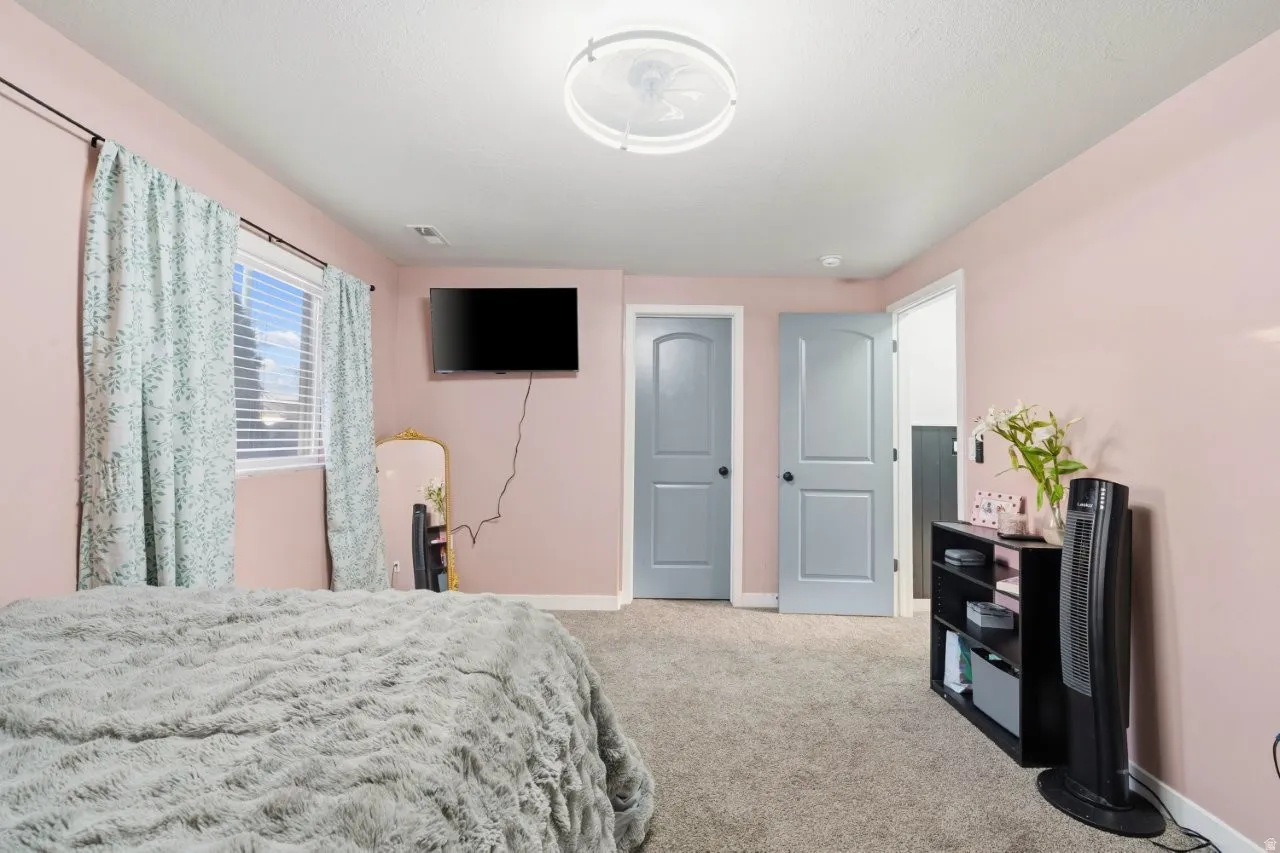 Bedroom featuring baseboards and light colored carpet