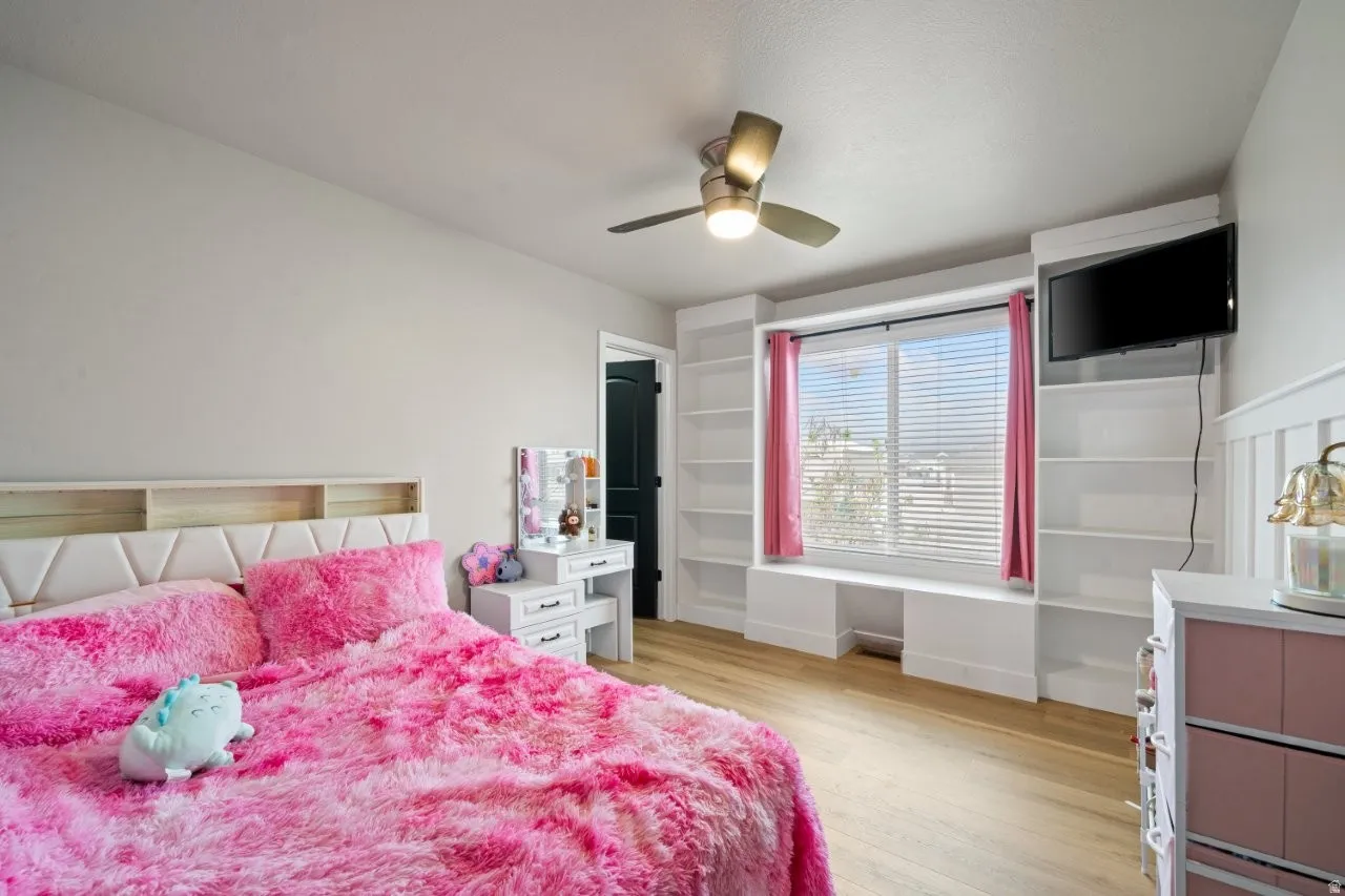 Light wood-finish flooring complements the neutral wall color