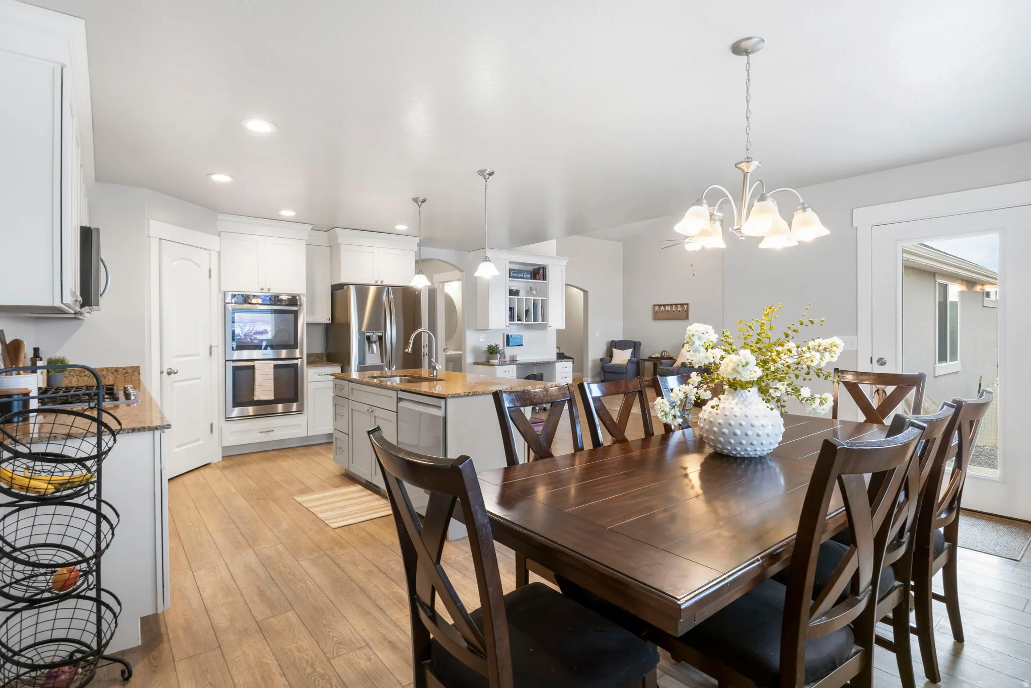 Dining room with light wood finished floors and suspended lighting