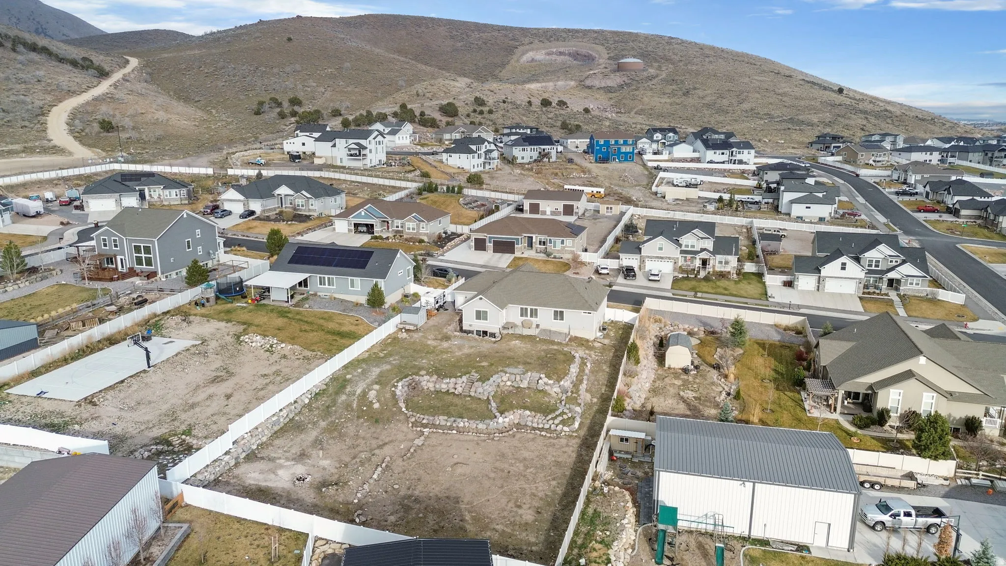 Aerial view of property's location with a mountainous background and nearby suburban area