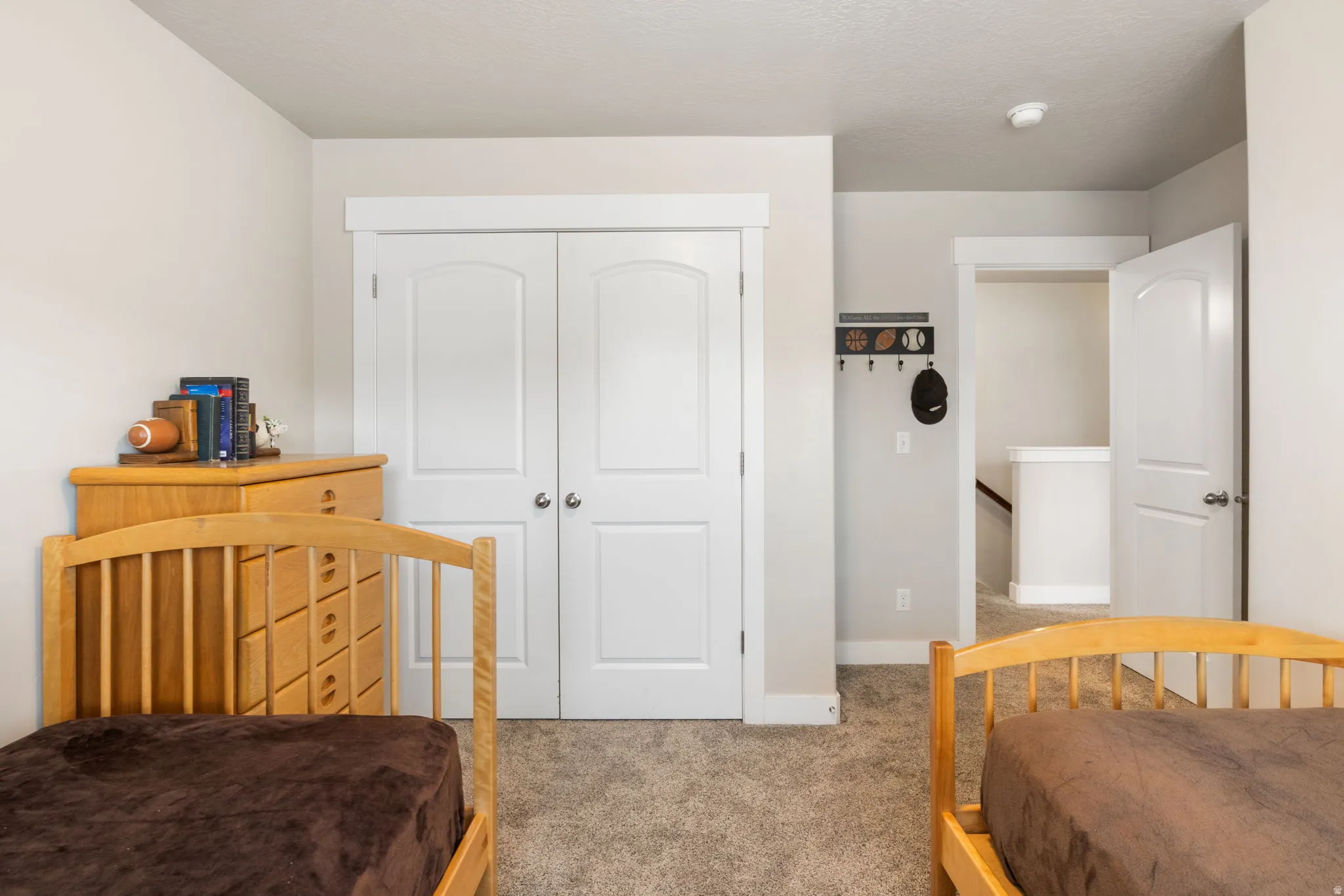 Bedroom featuring light carpet and a closet