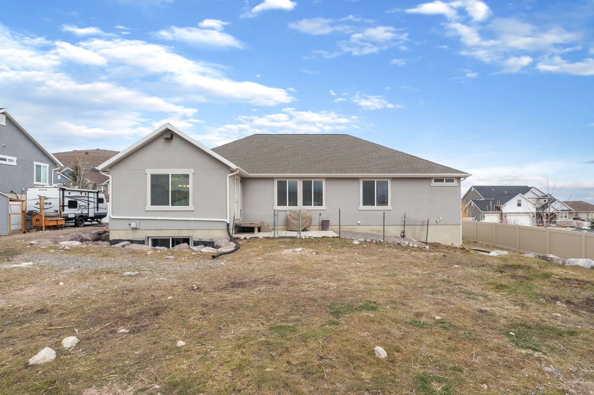 Rear view of house featuring stucco siding