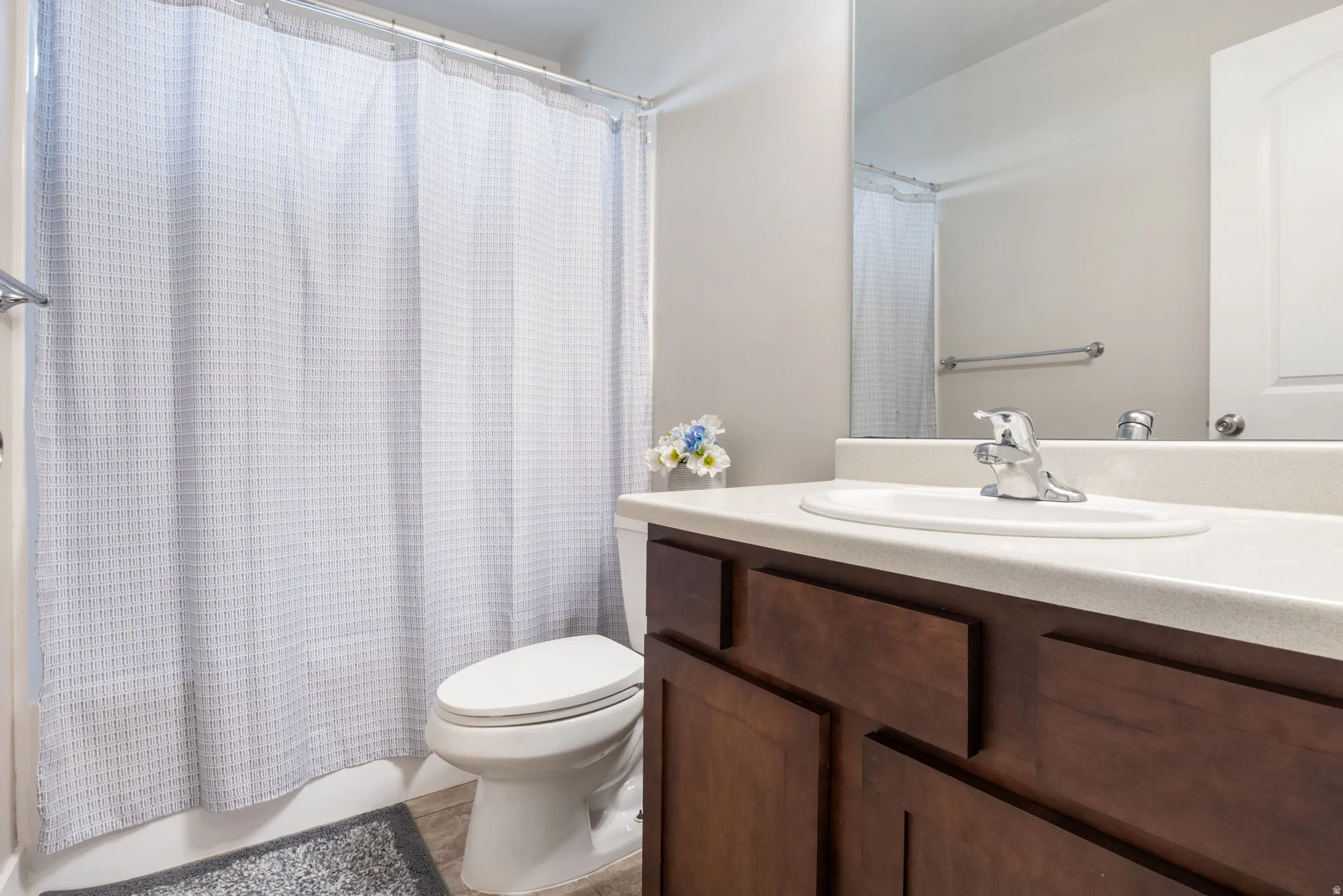 Bathroom featuring vanity and shower / bath combo with shower curtain