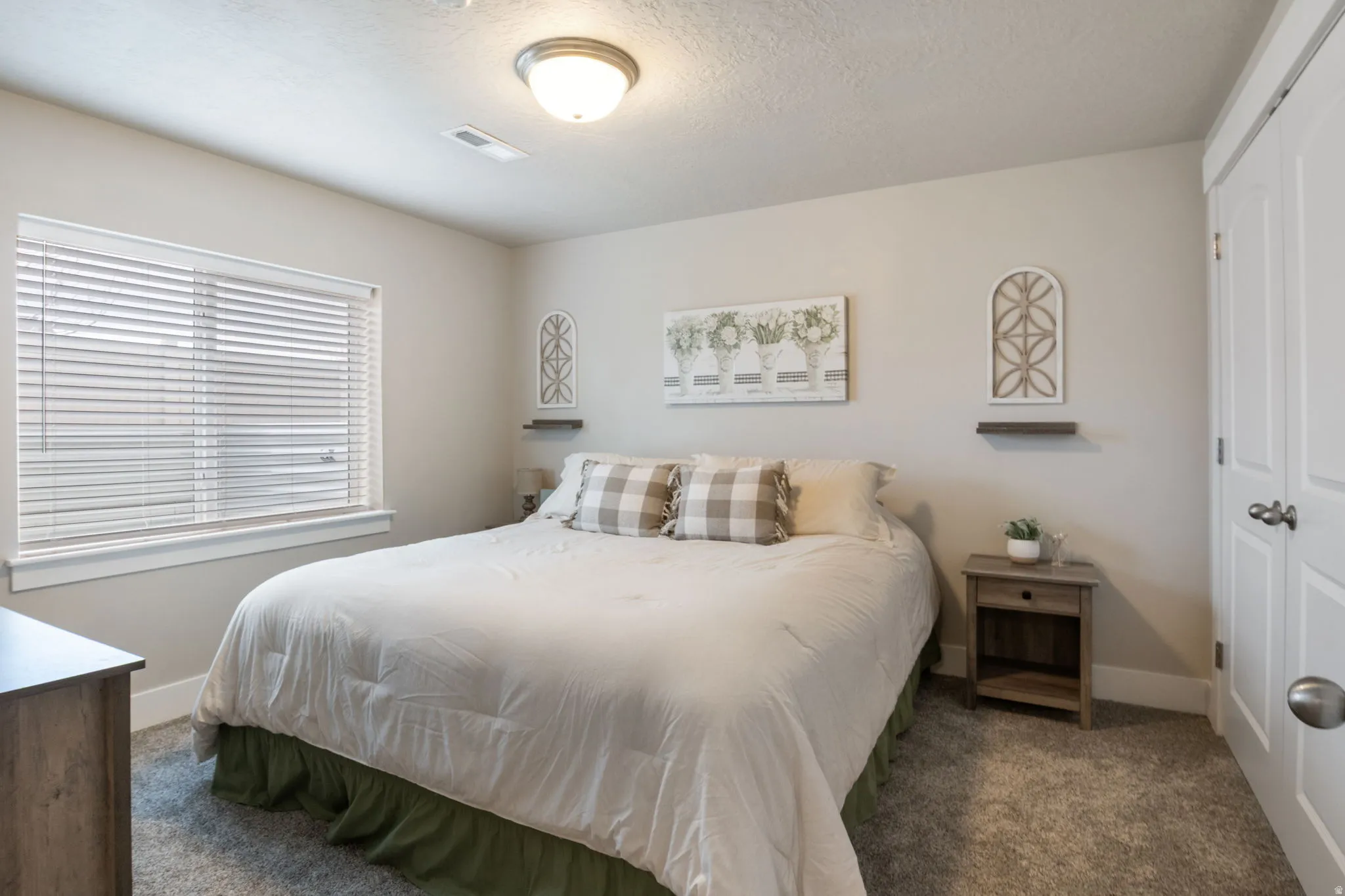 Bedroom featuring dark carpet, a closet, and a textured ceiling