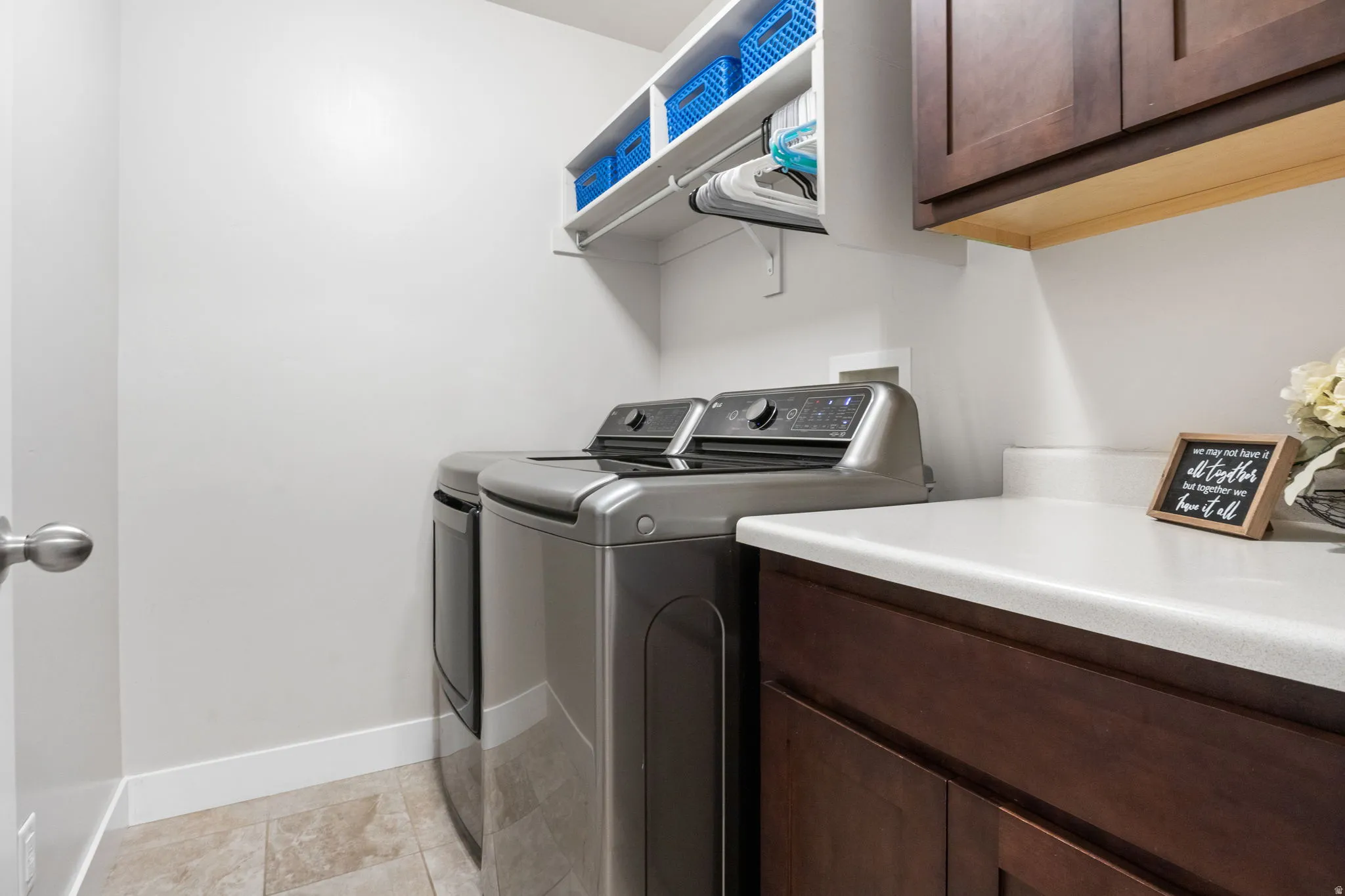 Laundry area featuring washer and dryer and cabinet space