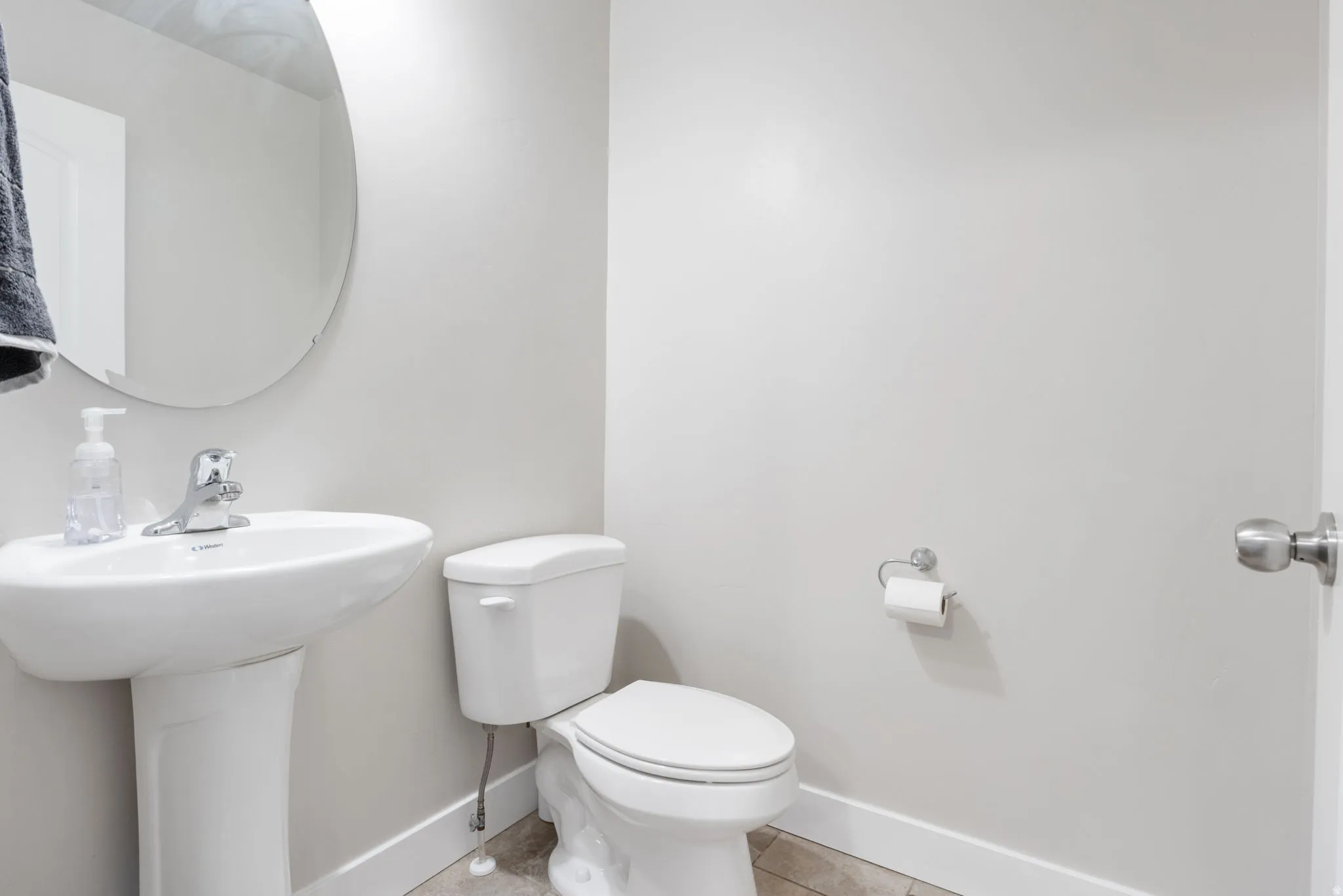 Half bathroom featuring baseboards and light tile patterned floors