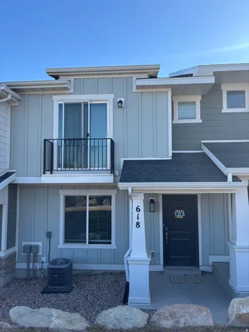 Modern exterior featuring light blue vertical siding and dark gray trim