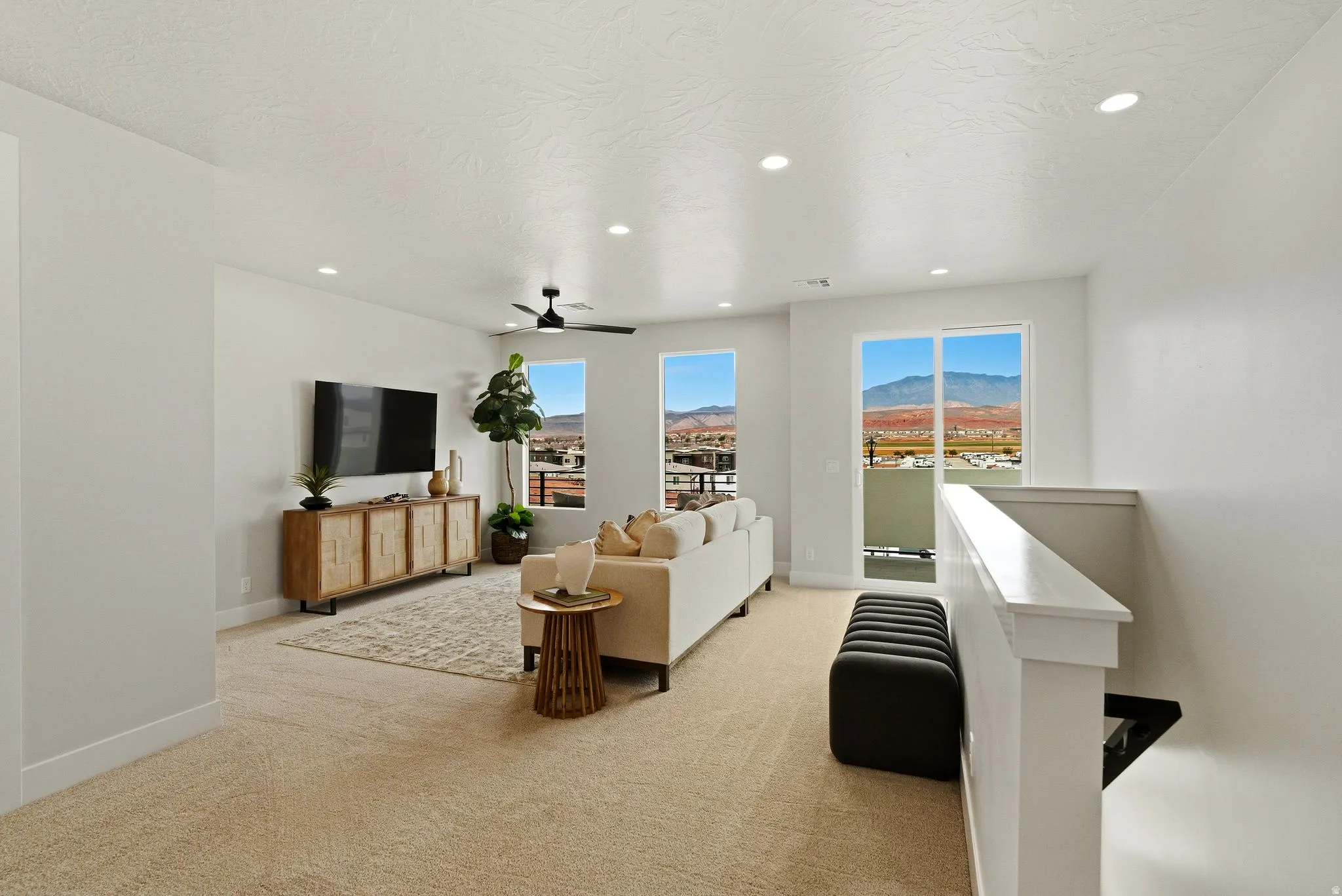 Living area featuring light carpet, recessed lighting, and a ceiling fan