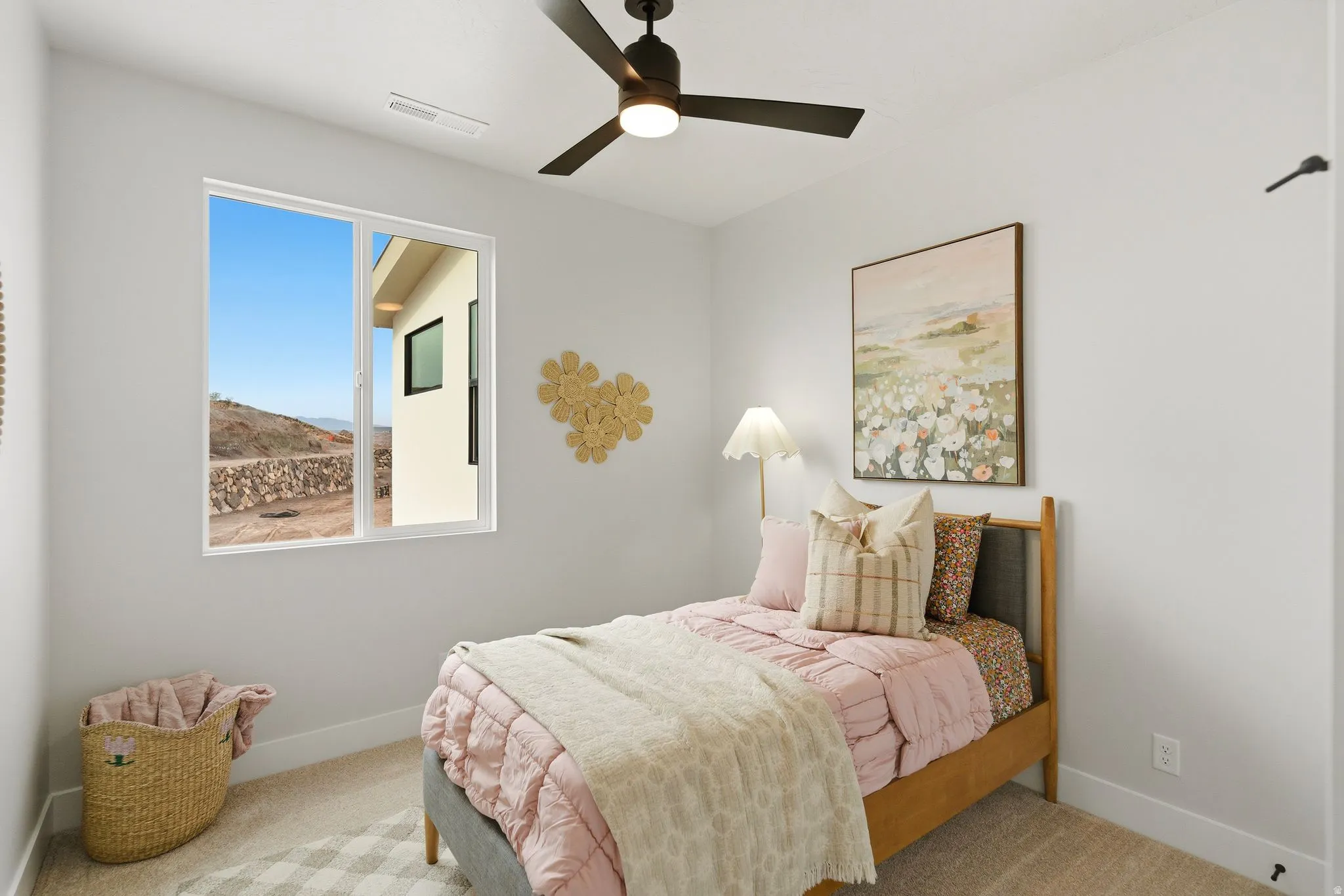 Carpeted bedroom featuring baseboards and ceiling fan