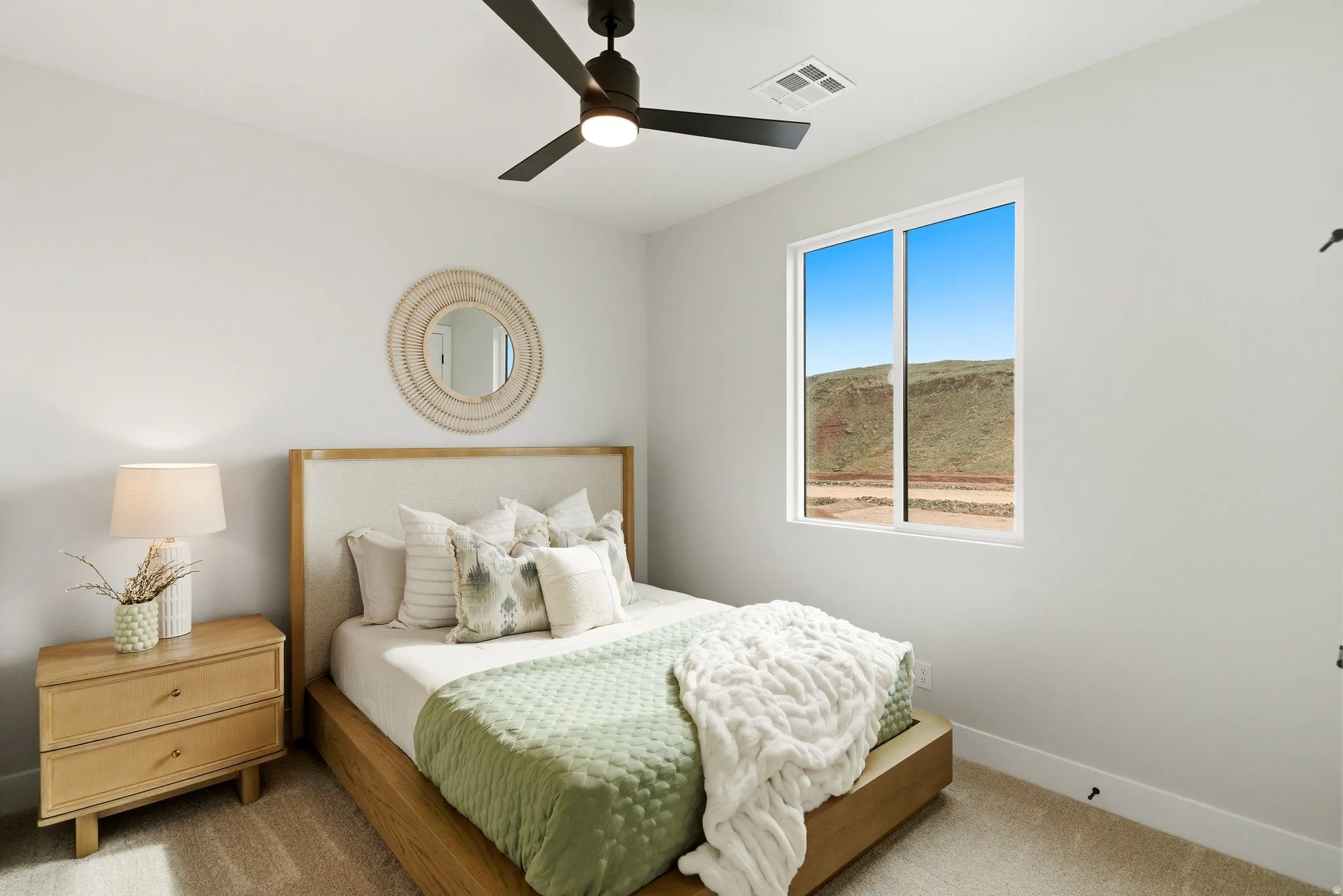 Bedroom featuring light carpet and a ceiling fan