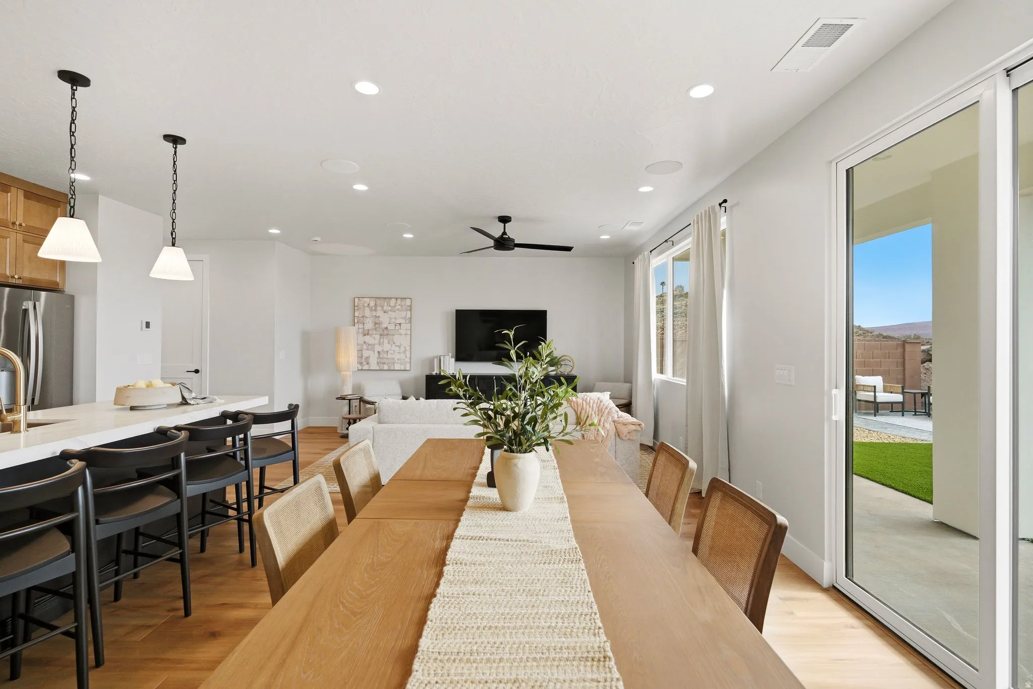 Dining space featuring light wood-style floors, recessed lighting, and ceiling fan