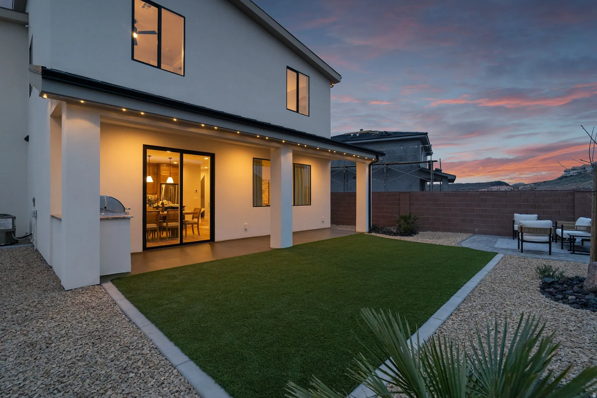 Back of property featuring a patio area, stucco siding, and a fenced backyard