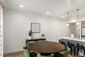 Dining room with dark wood finished floors and recessed lighting
