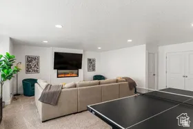 Recreation room featuring light carpet and recessed lighting